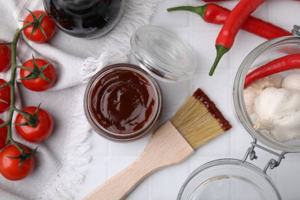 istock Marinade in jar, ingredients and basting brush on white tiled table, flat lay 2200966912