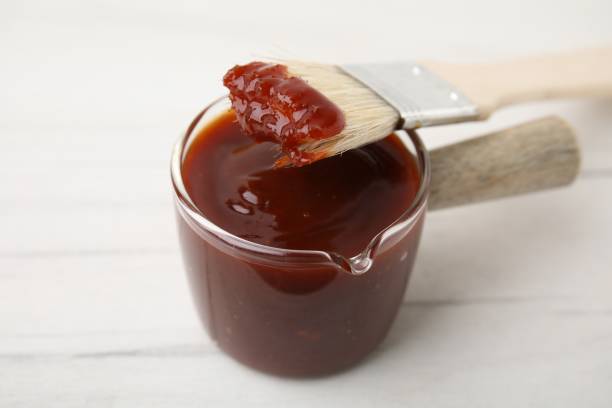 istock Marinade and basting brush on white table, closeup 2200966957