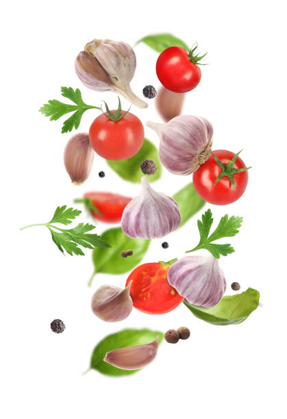 istock Fresh garlic, peppercorns, tomato and herbs falling on white background 2200968331
