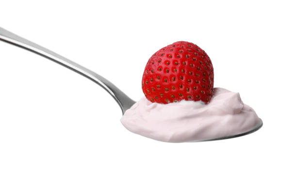 istock Delicious natural yogurt with fresh strawberry in spoon isolated on white 2200968430