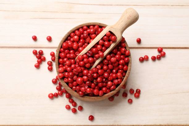istock Aromatic spice. Red pepper in bowl and scoop on white wooden table, top view 2200968459