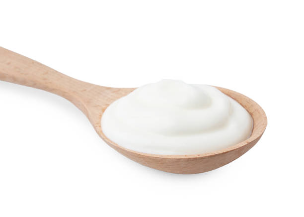 istock Delicious natural yogurt in spoon isolated on white 2200968524
