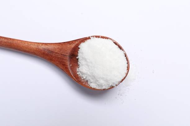 istock Natural salt in wooden spoon on white background, top view 2200968539