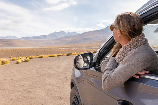istock Woman Enjoying Scenic Desert Drive from Car Window 2200968731