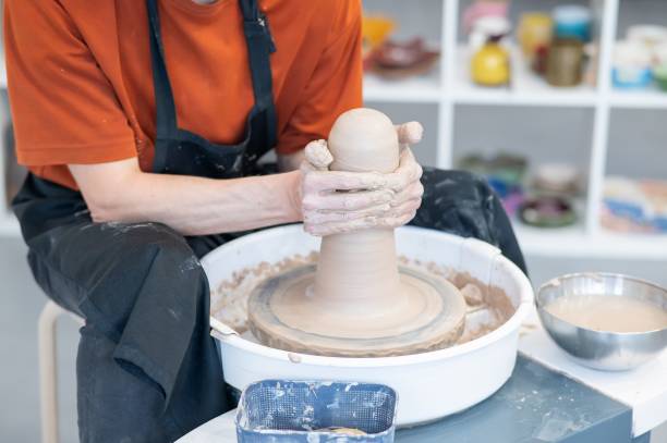 istock Close-up of a potter's hands working on a pottery wheel. 2200976055
