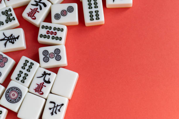 istock Mahjong tiles lined up on a red background 2200976288