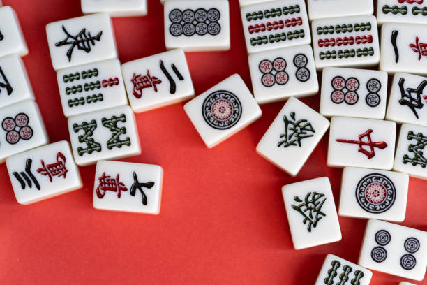 istock Mahjong tiles lined up on a red background 2200976356
