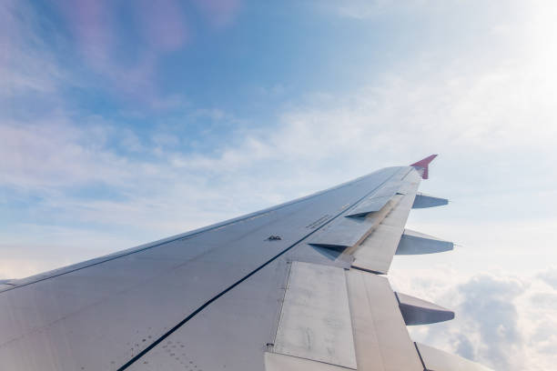 istock View from the airplane window at a beautiful cloudy sky and the airplane wing 2200979610