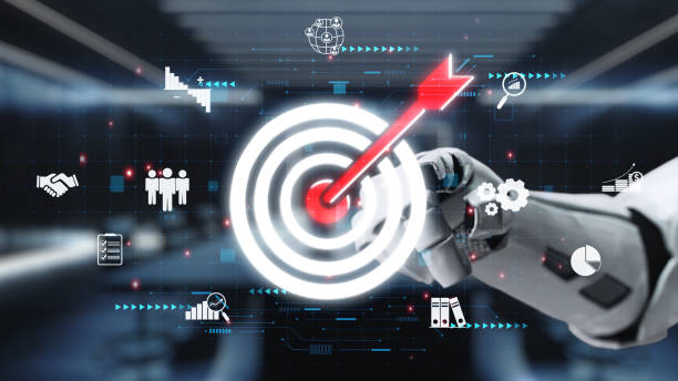 istock Futuristic robotic hand targeting a glowing bullseye with digital icons representing business success, technology, and data analysis in a modern workspace. Auvana 2200981432