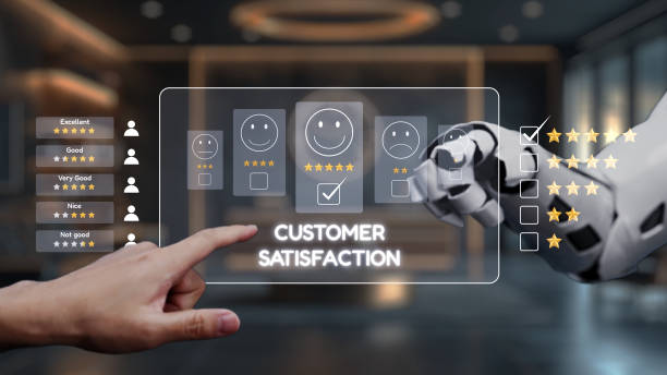 istock Hand of a human rating customer satisfaction on a digital screen with a robotic arm indicating positive feedback in a modern business setting. Auvana 2200981821