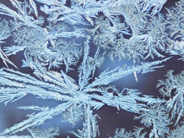 istock ice flowers on a window in winter time 2200981920