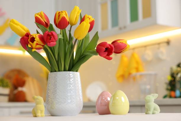 istock Bouquet of tulips and Easter decorations on white table indoors, closeup 2200984409