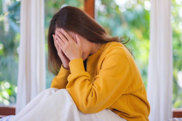 istock A woman get sick and headache at home 2200984967