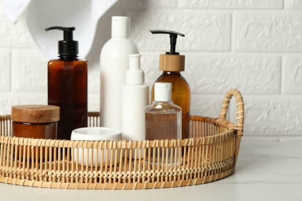 istock Bath accessories. Personal care products on white table near brick wall 2200986509