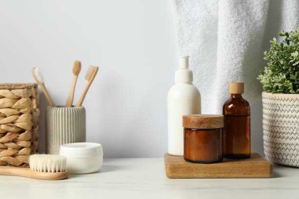 istock Different bath accessories and personal care products on light marble table against white wall 2200986572
