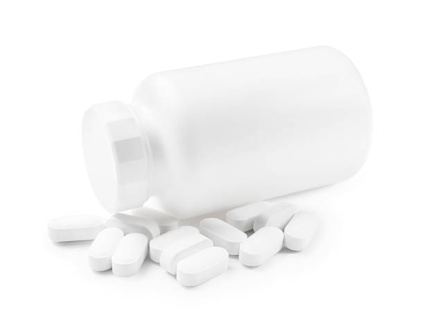 istock Vitamin pills and bottle isolated on white 2200986654
