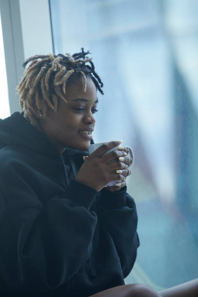 istock African descent young lady enjoying morning coffee 2200988249