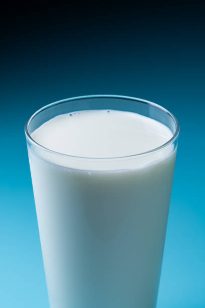 istock Glass of milk with blue background 2200991180