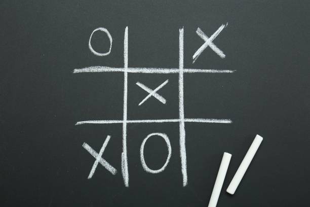 istock Tic tac toe game drawn on chalkboard, top view 2200991689