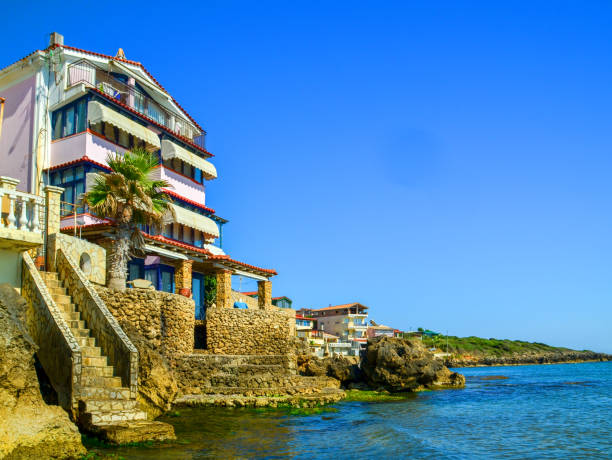 Greek-style religious building against backdrop turquoise sea, Paphos, Cyprus. Paphos seaside promenade.