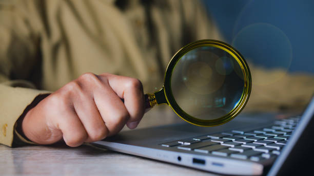 istock Businessman using magnifying glass searching data. Information in the internet world search technology Search Engine Optimization(SEO). 2200998311