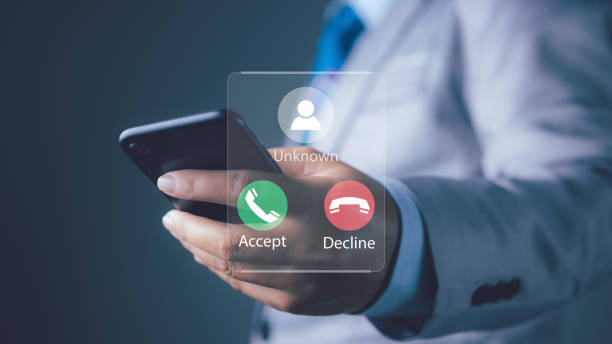 istock Businessman answering to incoming from an unknown caller. Phone call from unknown number. Scam, fraud or phishing with smartphone concept. 2200998342