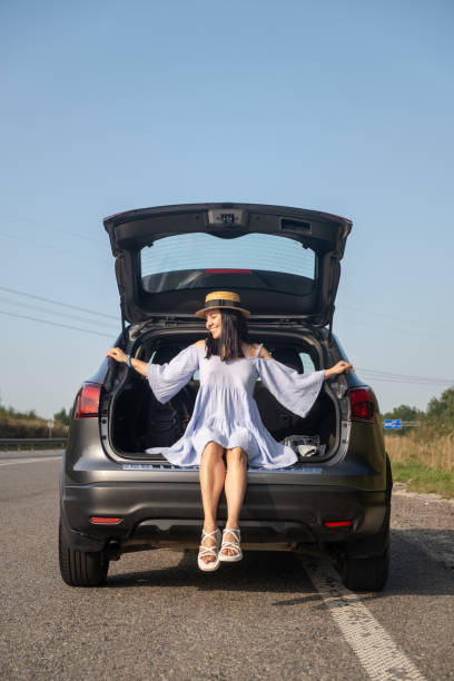 istock Woman Enjoying a Sunny Day by Her Car 2201001461
