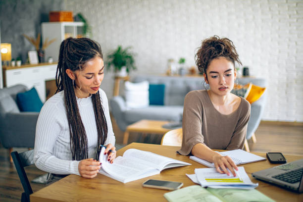 istock Two young college students studying together in dorm room 2201001717