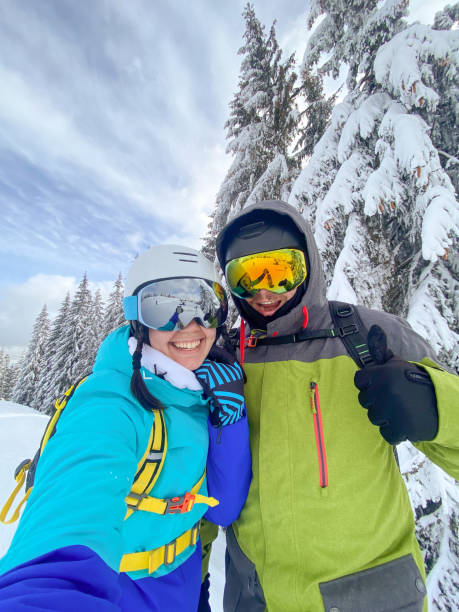 istock Couple Taking Selfie on Snowy Mountain 2201001877