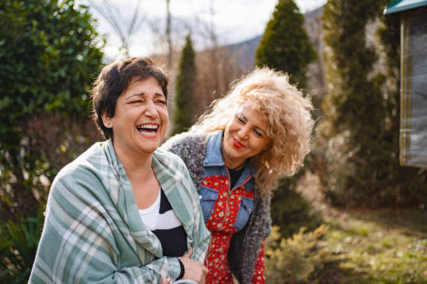 istock Two women laughing during group drama psychotherapy session 2201002693