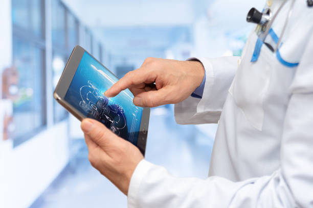 istock Doctor interacts with digital tablet in modern medical facility showcasing advanced technology and patient care 2201006359