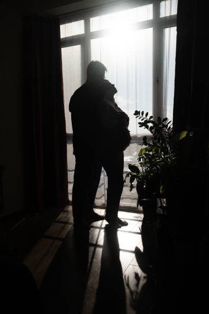 istock Intimate Moment of Expecting Parents by the Window 2201007558