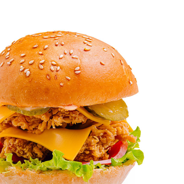 istock Delicious sesame seed bun sandwich with crispy fried chicken, cheese, and fresh vegetables 2201008444