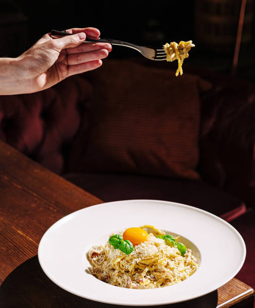 istock Delicious pasta dish served with fresh ingredients and a vibrant egg yolk in an upscale restaurant setting 2201008957