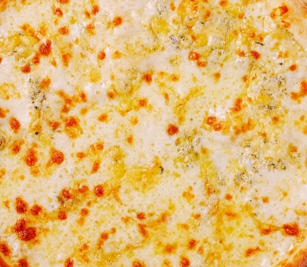 istock Delicious cheesy pizza served on a wooden platter in a cozy restaurant setting during dinner time 2201009129