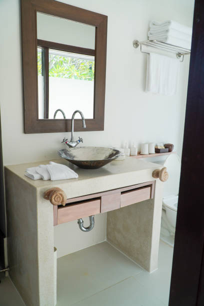 istock Bathroom interior with sink, mirror and towel on countertop 2201010407