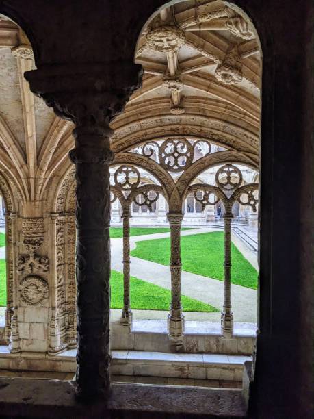 istock Through an archway at Jeronimos Monastery with stone carvings and a courtyard 2201011239