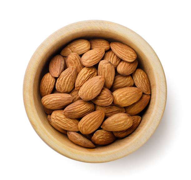 istock Almond nuts in a wooden plate on a white background. Top view 2201014944