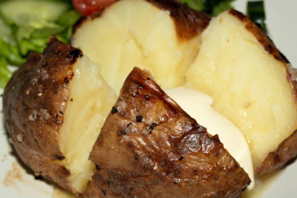 Close up of a Jacket Potato with Salad on White Background