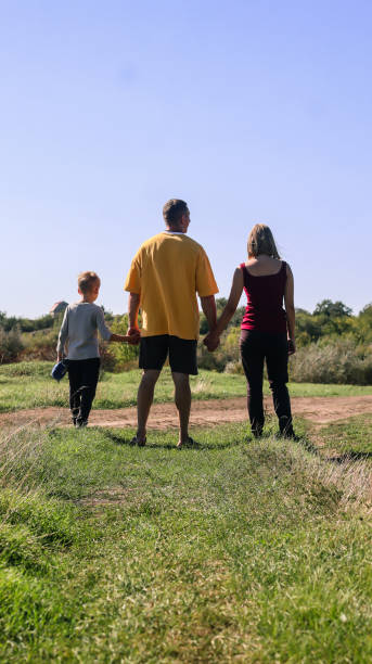 istock father with children on a walk in nature on a summer day 2201019709