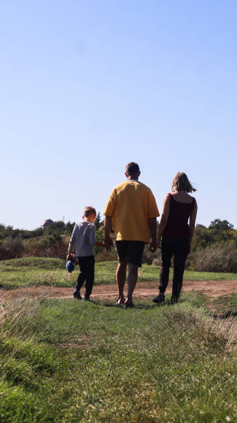 istock father with children on a walk in nature on a summer day 2201019736