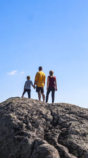 istock father with children on a walk in nature on a summer day 2201019739