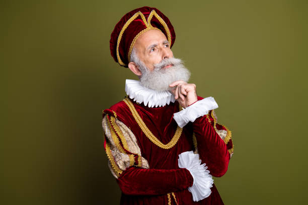 istock Renaissance nobleman in elaborate costume with contemplative expression against khaki background 2201022222