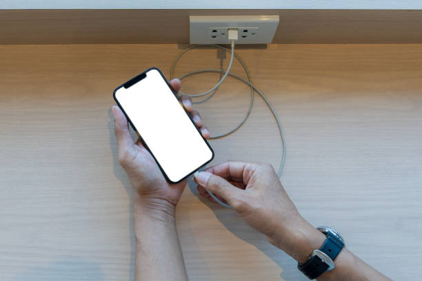 istock Hands holding phone with charged battery 2201022684