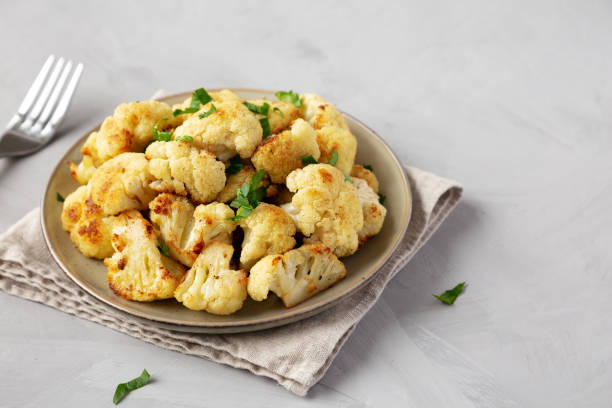 istock Homemade Roasted White Cauliflower on a Plate, side view. Space for text. 2201024312