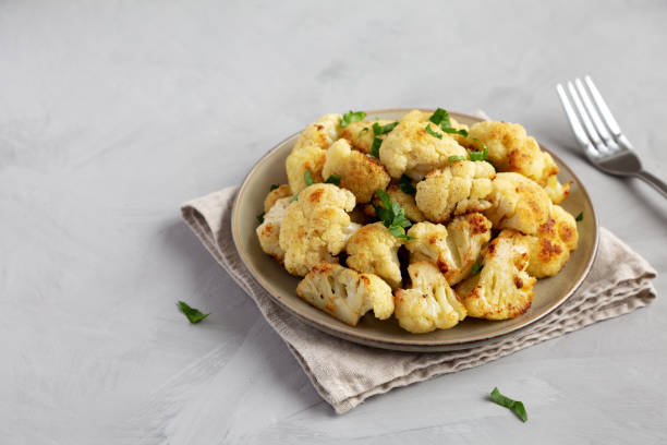 istock Homemade Roasted White Cauliflower on a Plate, side view. Copy space. 2201024759