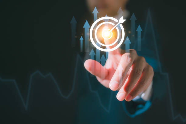 istock Goal Setting. A Businessman's Hand Points to the Glowing GOAL with a Dart Target Board work schedules, and the achievement of organizational objectives 2201025656