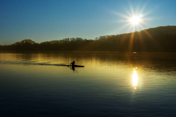 Rowers on a lake at sunrise