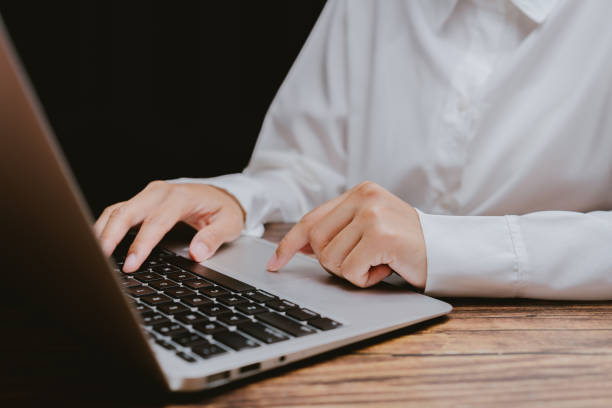 istock Professional Hands Typing on Laptop Keyboard in Minimalist Workspace 2201031302