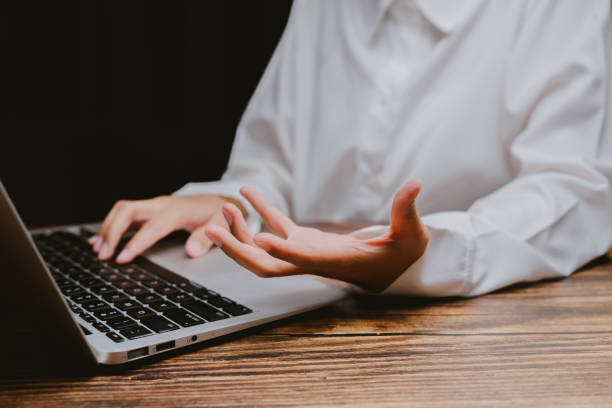 istock Person Working on Laptop with Hands Gesturing in Professional Setting 2201031316